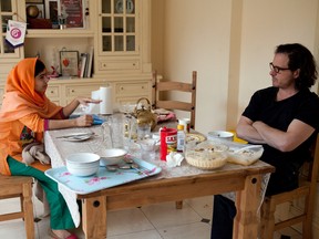 In this Dec. 17, 2013 photo released by Twentieth Century Fox Film Corporation, Malala Yousafzai, left, speaks with director Davis Guggenheim in Birmingham, England during the filming of the documentary, "He Named Me Malala," released in U.S. theaters on Friday. (Caroline Furneaux/Twentieth Century Fox Film Corporation via AP)