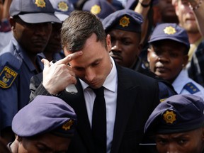 In this Monday, Oct. 13, 2014 file photo, Oscar Pistorius gestures as he leaves the high court, in Pretoria, South Africa. (AP Photo/Themba Hadebe, File)