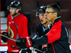 Ottawa Senators defenceman Patrick Wiercioch talks with head coach Dave Cameron during practice at the Canadian Tire Centre in Ottawa, Ont. on Friday September 25, 2015. (Errol McGihon/Postmedia Network)