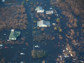 In this aerial photo, homes are seen under the floodwaters caused by Hurricane Joaquin in the Southern area of Long Island, Bahamas, Monday, Oct. 5, 2015.  Joaquin unleashed heavy flooding as it roared through sparsely populated islands in the eastern Bahamas last week, as the Coast Guard searched for crew members of the U.S. container ship El Faro which they concluded sank near the Bahamas during the storm. (AP Photo/Tim Aylen)