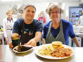 Lunch is served at the Inn of the Good Shepherd's soup kitchen Tuesday in Sarnia. A Thanksgiving-themed meal is on tap for the Inn's annual Harvest Dinner fundraiser Wednesday. Pictured with the prepared food are volunteers Bridget Seabrook, left, and Jane Dolinsek, two in a group of seven who were preparing the Tuesday meal. Tyler Kula/Sarnia Observer/Postmedia Network