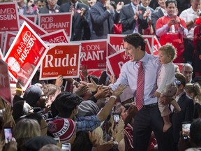 Liberal leader Justin Trudeau holds his son Hadrien as he exits a campaign rally in Brampton, Ontario, Canada October 4, 2015. (REUTERS/Mark Blinch)