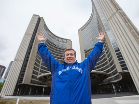 Toronto Mayor John Tory wears a Blue Jays jacket outside City Hall in Toronto Tuesday October 6, 2015 after a flag raising ceremony to kick of the team's playoff action. (Ernest Doroszuk/Toronto Sun)