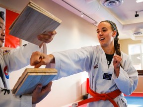 Kim McRae, right, a Canadian Olympic luger, practises her taekwondo skills with her coach Seoung Min Rim in Calgary, Alta., Tuesday, Oct. 6, 2015.THE CANADIAN PRESS/Jeff McIntosh