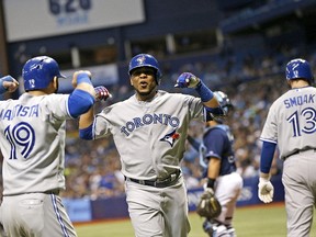 ST. PETERSBURG, FL - OCTOBER 3: Edwin Encarnacion #10 of the Toronto Blue Jays celebrates his two-run home run with teammate Jose Bautista #19 during the sixth inning of a game against the Tampa Bay Rays on October 3, 2015 at Tropicana Field in St. Petersburg, Florida.   Brian Blanco/Getty Images/AFP== FOR NEWSPAPERS, INTERNET, TELCOS & TELEVISION USE ONLY ==