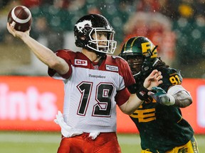 Stampeders QB Bo Levi Mitchell (19) gets the ball away while being chased by Eskimos' Marcus Howard (91) during CFL action in Edmonton on Saturday, Sept. 12, 2015. (Perry Nelson/Postmedia Network)