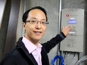 Derek Chiu, of Sieco-Tech Canada Inc., demonstrates a multi-unit smart meter panel in a newly built apartment building on Oxford Street East in London Tuesday. (CRAIG GLOVER, The London Free Press)