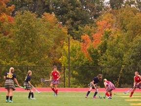 The trees provide a colourful backdrop as the Medway Cowboys and Strathroy Saints play field hockey at City Wide Fields on Tuesday. (MIKE HENSEN, The London Free Press)
