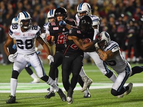 Ottawa Redblacks' Jeremiah Johnson is tackled by Toronto Argonauts' Ricky Foley during second quarter CFL action in Ottawa on Tuesday, Oct 6, 2015. THE CANADIAN PRESS/Sean Kilpatrick