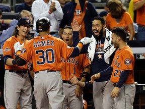 Astros centre fielder Carlos Gomez (30) celebrates with teammates after hitting a solo home run against the Yankees during the fourth inning of the American League Wild Card game at Yankee Stadium in New York on Tuesday, Oct. 6, 2015. (Adam Hunger/USA TODAY Sports)