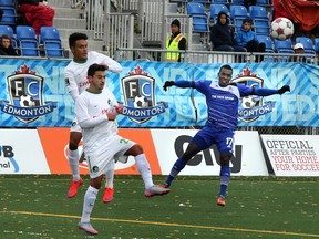 FC Edmonton’s Lance Laing gets the ball by a New York Cosmos’ defenders at Clarke Park on Sept. 27. The Eddies won that game 2-1. (Perry Mah, Edmonton Sun)