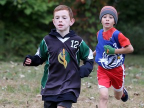 Adam Trella, left, of St. Elizabeth leads Colin Reaume of Christ the King at the St. Clair Catholic District School Board cross-country championship meet for Chatham-Kent schools at the Thames Grove Conservation Area in Chatham, Ont., on Saturday, Oct. 3, 2015. Reaume won the race for Grade 3 boys and Trella finished second. 
Mark Malone/Chatham Daily News/Postmedia Network