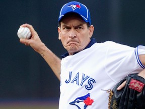Actor Charlie Sheen throws out the ceremonial first pitch prior to the start of the American League MLB baseball game between the Toronto Blue Jays and Chicago White Sox in Toronto August 14, 2012. (REUTERS/Fred Thornhill)