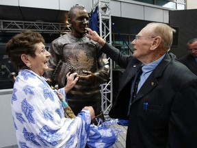 Johnny Bower and his wife Nancy talk beside his statue on Legends Row at the Maple Leafs’ Fan Fest in Toronto on Saturday September 6, 2014. (Craig Robertson/Toronto Sun/Postmedia Network)