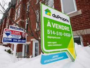 For sale signs are seen in front of a Montreal condominium, Tuesday, March 17, 2015. A new report on real estate trends predicts that foreign investors could start looking beyond Toronto and Vancouver and towards markets such as Montreal and Saskatoon in the year ahead. THE CANADIAN PRESS/Paul Chiasson