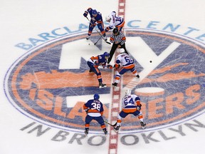 In this July 8, 2015, file photo, New York Islanders forward Miks Indrasis (28) and Victor Crus-Rydberg (61) face off during the New York Islanders’ Blue and White scrimmage at Barclays Center, the team’s new home, in New York. (AP Photo/Kathy Willens, File)