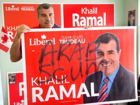 London Fanshawe Liberal candidate Khalil Ramal stands with one of his defaced campaign signs. (Derek Ruttan, The London Free Press)