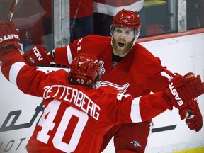 Detroit Red Wings forward Dan Cleary celebrates with teammate Henrik Zetterberg in Game 5 of the Stanley Cup final in Detroit, Michigan, June 6, 2009.