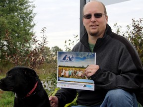 SARAH HYATT/THE INTELLIGENCER
Quinte Humane Society executive director Frank Rockett, with Vader, displays the society's new calendar, outside the shelter. The calendar features successful adoptions from the shelter paired with community figures. Proceeds from sales help with operational costs at the shelter. Vader, 4, is up for adoption.