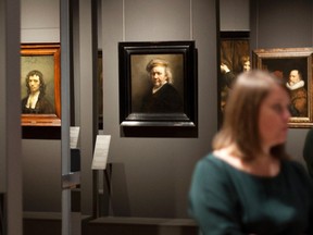 A woman admires paintings during a press preview of an exhibition called "Dutch Self-Portraits - Selfies of the Golden Age", at the Mauritshuis museum in The Hague, Wednesday Oct. 7, 2015. (AP Photo/Mike Corder)