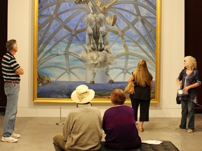 Gregory and Sheila Brown, seated, examine Salvador Dali's four-metre-high work "Santiago El Grande" of the Masterworks from the Beaverbrook Art Gallery at the Judith & Norman Alix Art Gallery. (Tyler Kula, Observer file photo)