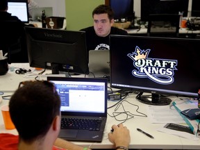 In this Sept. 9, 2015, file photo, Len Don Diego, marketing manager for content at DraftKings, a daily fantasy sports company, works at his station at the company’s offices in Boston. (AP Photo/Stephan Savoia, File)