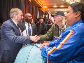 NDP leader Tom Mulcair speaks to native drummers at the Assembly of First Nations meeting Wednesday, October 7, 2015 in Edmonton. THE CANADIAN PRESS/Ryan Remiorz