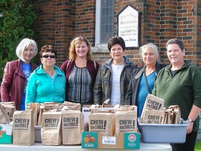 Volunteers in Kingston gathered outside Princess Street United Church and hand out 'Chew on This!' lunch bags to help bring awareness to the national poverty issue in this file photo. (Sisters of Providence St. Vincent de Paul)