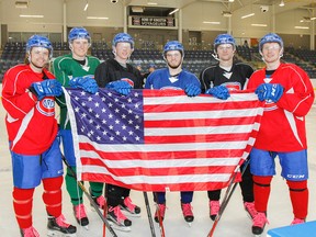 Kingston Voyageurs six American players, left to right, Ian Harris, Tom Abrams, Nick Shantz, Mason Corliss, Jack Zielinski and Danny Bosio pose with their country's flag before practice at the Invista Centre on Tuesday.
(Julia McKay/The Whig-Standard)