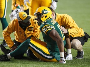 Sahmawd Chambers is checked on the field during a game against the Montreal Alouettes in Sept. 2014, a week before the injury that left him with a torn ACL. (Ian Kucerak, Edmonton Sun)
