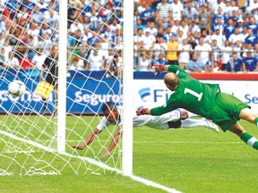 Carlo Costly (left) heads to score one of Honduras’ eight goals against Canada’s goalkeeper Lars Hirschfeld during World Cup qualifying in 2012. (AFP)