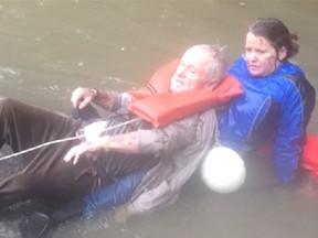 Ottawa senior George Osterhues, 87, is pulled from a raging, overflowing creek after his car became trapped in the water near Columbia, S.C., on Sunday. (Screengrab courtesy WSOC-TV)