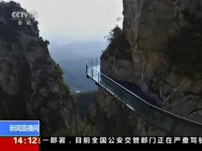 A general view of a section of a glass walkway along mountain side at Yuntai Mountain Park in China's northern Henan province, in this still image obtained from video on Oct. 7, 2015. An official at the park said on Wednesday that the glass walkway, which tourists reported a panel of which had shattered, met national safety standards during routine inspections, state media reported. (REUTERS/CCTV via REUTERS TV)