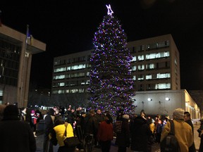 A crowd mills around following the annual lighting of the Christmas tree at City Hall on Main Street on Fri., Nov. 14, 2014.
