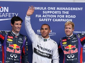 Mercedes driver Lewis Hamilton stands with Red Bull drivers Sebastian Vettel and Mark Webber at the 2013 Belgian Grand Prix. (WENN.com)