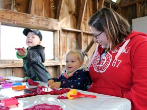 Sarnia's Rozealea Kameka, two, and her mother, Samantha, participate in a craft activity at St. Clair Child and Youth Services' annual Thanksgiving lunch Thursday at Canatara Park. The Sarnia-Lambton agency has been hosting the event for around 30 years. (Terry Bridge/Sarnia Observer/Postmedia Network)