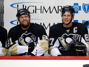 In this Sept. 22, 2015, file photo, Pittsburgh Penguins' Sidney Crosby and Phil Kessel sit on the bench during the first period of an exhibition NHL hockey game against Carolina Hurricanes in Pittsburgh. (AP Photo/Gene Puskar, File)