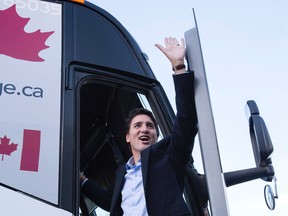 Liberal Leader Justin Trudeau waves as he boards his campaign bus following a campaign event in Vaughan. (THE CANADIAN PRESS/Paul Chiasson)