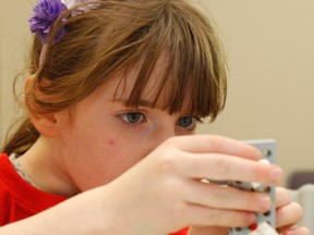 Grace Colby, a participant in the Bricks4Kidz program, puts in the next piece on her lego model in the Creativity Centre at the Boys and Girls Club of Kingston west-end community hub at the Frontenac Mall, on Thursday October 8, 2015. Julia McKay/The Kingston Whig-Standard/Postmedia Network