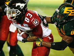 Deon Lacey tackles Calgary Stampeders Nathan Slaughter duringtheir game Sept. 12 at Commonwealth Stadium. (Perry Nelson, Edmonton Sun)
