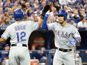 Rangers catcher Robinson Chirinos (right) celebrates with second baseman Rougned Odor (12) after hitting a two-run home run against the Blue Jays in the fifth inning in Game 1 of the ALDS in Toronto on Thursday, Oct. 8, 2015. (Nick Turchiaro/USA TODAY Sports)