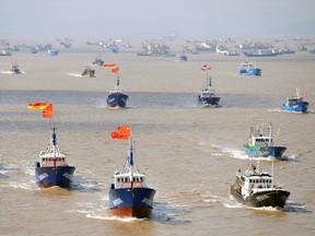 Fishing boats are seen departing from Shenjiawan port in Zhoushan, Zhejiang province towards the East China Sea fishing grounds, in this Sept. 17, 2012 file photograph. (REUTERS/Stringer/Files)