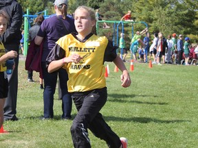 Abby Bos runs to the finish line last Thursday during the cross country meet at Huron Centennial Public School. Bos, a Hullett student, won first place in the age 11 girls category. (Laura Broadley Clinton News Record)