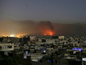 Smoke rises during clashes between forces loyal to Syria's President Bashar al-Assad and the Army of Islam fighters, on the eastern mountains of Qalamoun overlooking the town of Douma, eastern Ghouta in Damascus October 1, 2015. Picture taken October 1, 2015. REUTERS/Bassam Khabieh