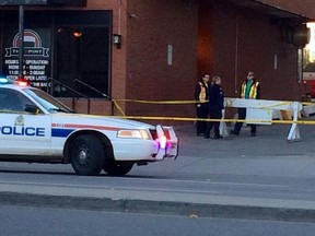 Police investigate the scene of a shooting near Jasper Avenue and 109 Street, the morning of Oct. 9, 2015. (Perry Mah/Edmonton Sun)