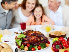 FOTOLIA  IMAGE FOR ONLINE USE ONLY: Image of roasted turkey on holiday table and family on background