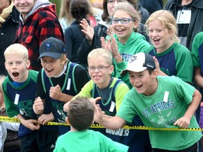 Members of the St. Patrick's Kinkora Crusaders - Mackenzie DeJong (back row, left) and Gabby DeJong, and Carter DeGroot (front row left), Ben Fizell, Kaden DeGroot and Brandon Dietrich - cheer on Nate Van Bakel during the annual Patrick Cook Memorial cross-country event at Stratford Education and Recreation Centre last Tuesday, Oct 6 in Stratford. More than 1,100 competitors participated in the event, which continues to grow. SCOTT WISHART/POSTMEDIA NETWORK