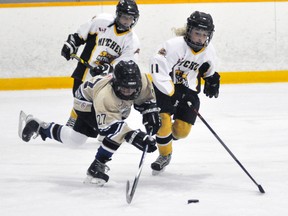Mitchell's Emma French (11) battles for the loose puck with Olivia Goodburn (27) of the BCH Pee Wee girls during league action in Mitchell Oct. 7. ANDY BADER/MITCHELL ADVOCATE