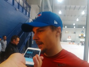 Ottawa Senators captain Erik Karlsson wears a Blue Jays cap after the team's practice in Toronto ... where he and teammates were planning to attend the ALDS Game 2 between Toronto and Texas. (BRUCE GARRIOCH Ottawa Sun)