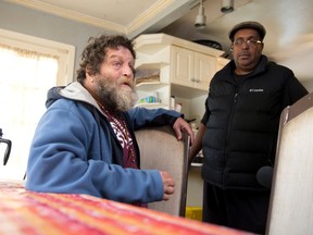 People Helping People client Brian MacDonald talks with a reporter as PHP founder Keith Charles watches at a group home on Clarke Road in London, in this file photo. (Free Press files)